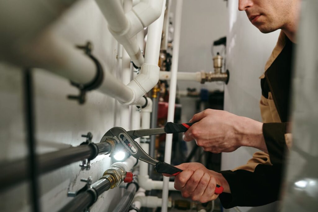 Plumbers maintaining commercial plumbing pipes in Gibsonton