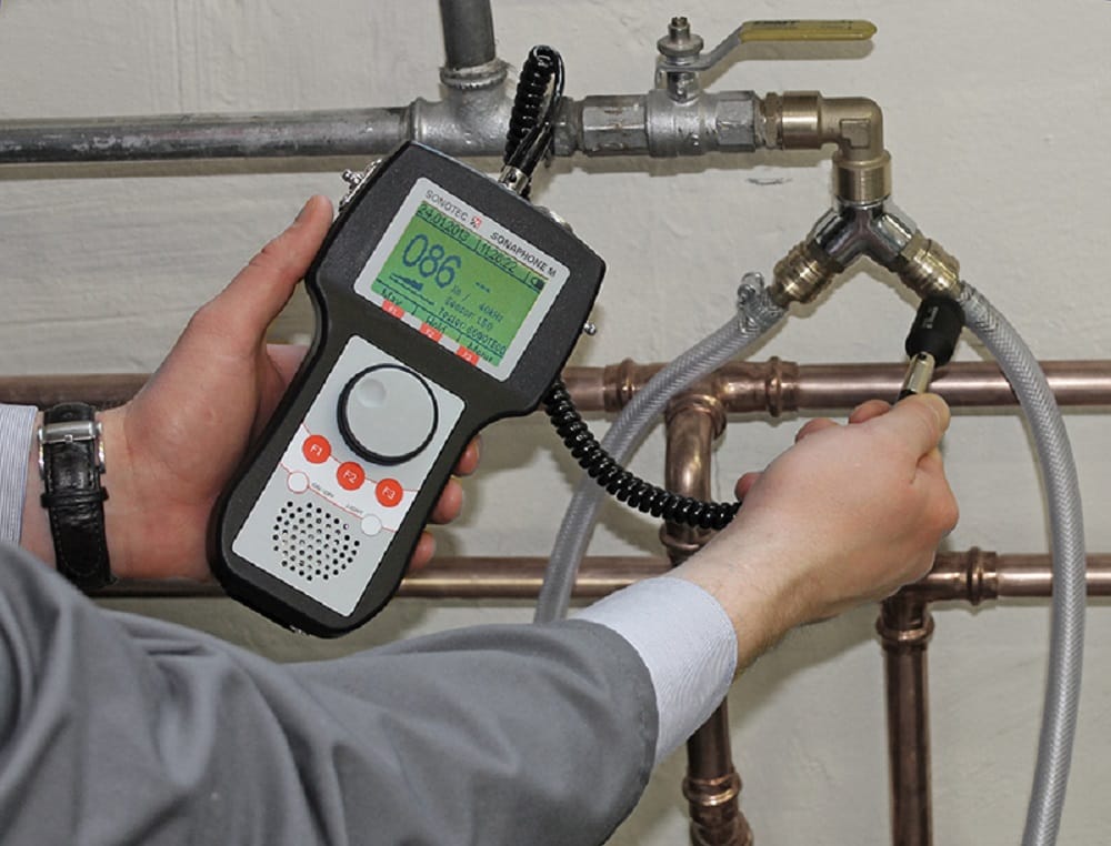 Plumber testing pipes with electronic leak detection equipment in Gibsonton