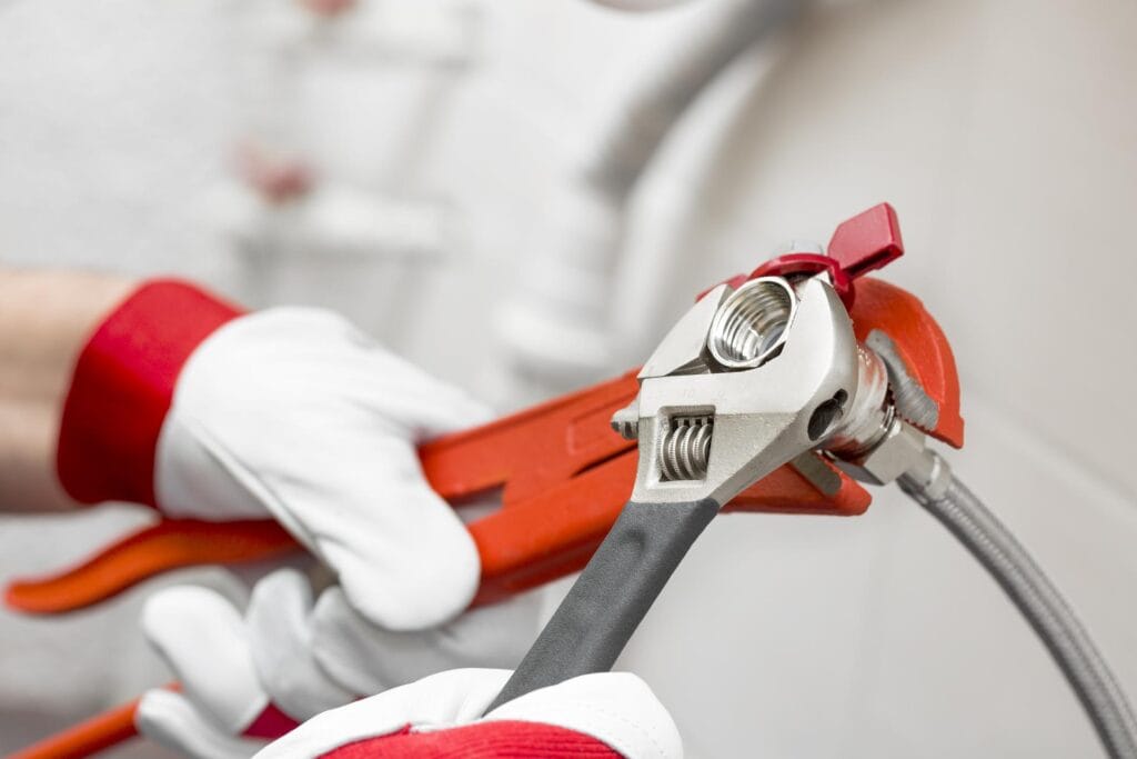 Plumber holding pipe wrenches for an emergency repair in Gibsonton