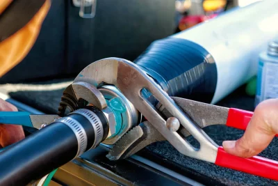 Technician tightening an industrial pipe connection in Gibsonton