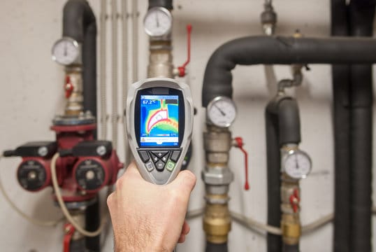 Plumber using a thermal imaging camera to inspect pipes in Gibsonton