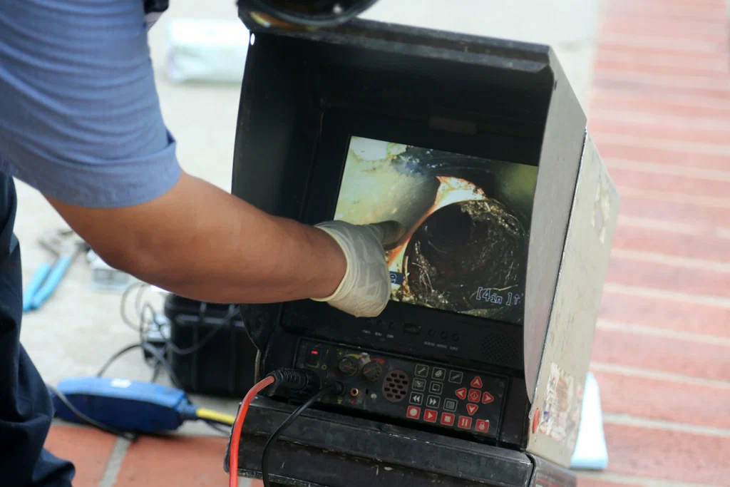 Technician viewing a drain inspection camera in Gibsonton