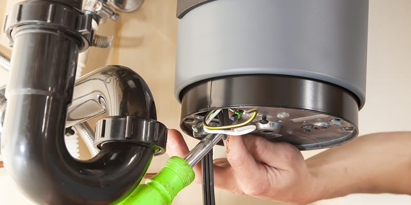 Technician repairing the heating element of a water heater in Gibsonton