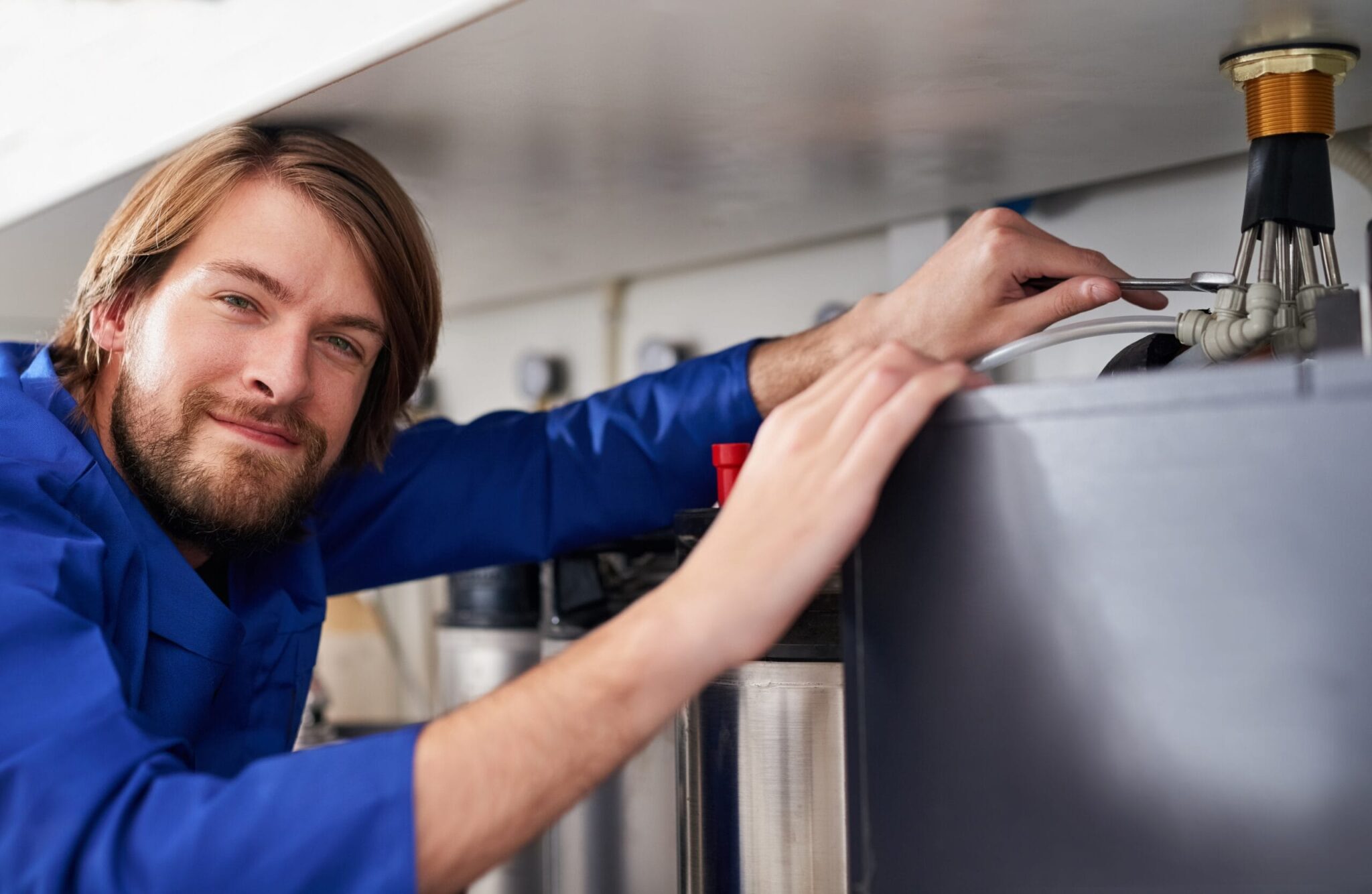 Technician servicing a residential water heater tank in Gibsonton