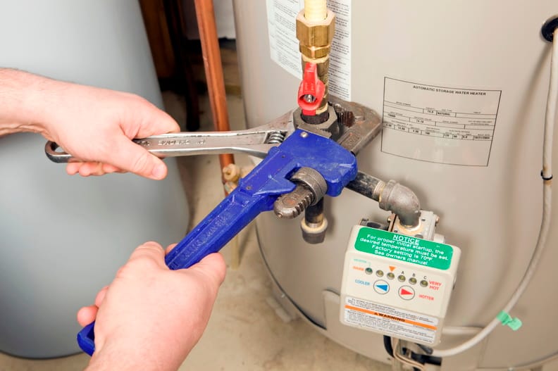 Plumber repairing a water heater valve in Gibsonton